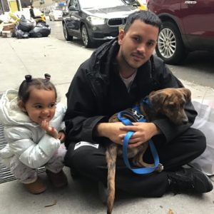 Sofia and Bernardo Rodriguez sit outside the ASPCA's NYC Adoption Center with their just-adopted four-month old puppy, Sorrento